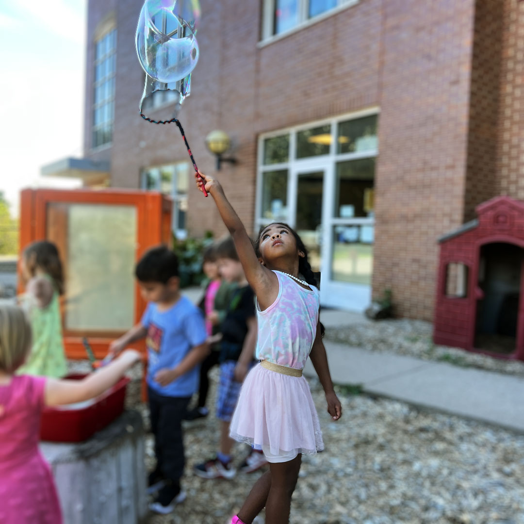 bubble-preschool-girl Preschool girl making bubbles image
