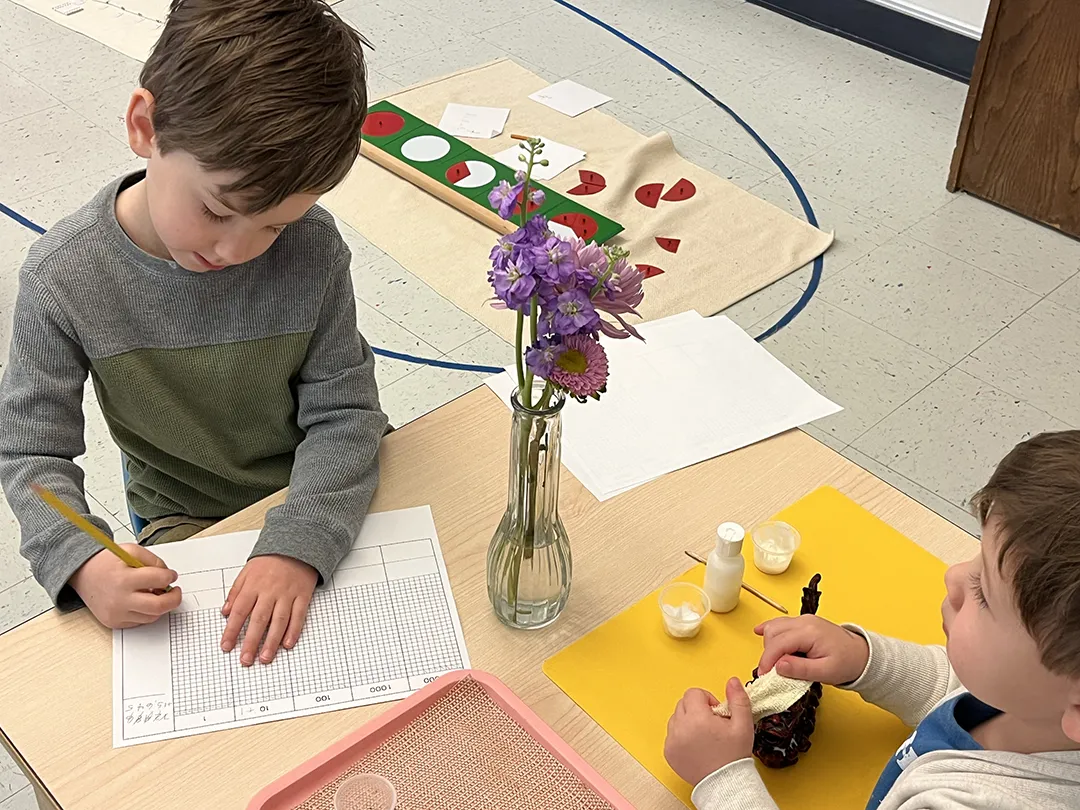 Rivermont Montessori students sitting at their desk.